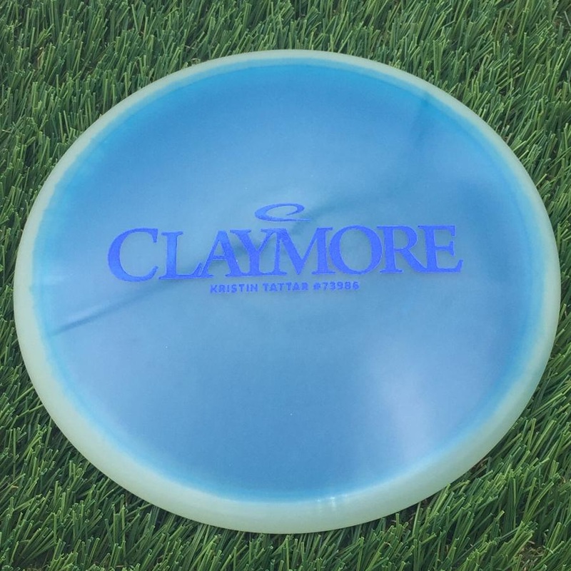 Latitude 64 Opto Orbit Moonshine Glow Claymore with Kristin Tattar #73986 Stamp – 178g – Translucent Blue